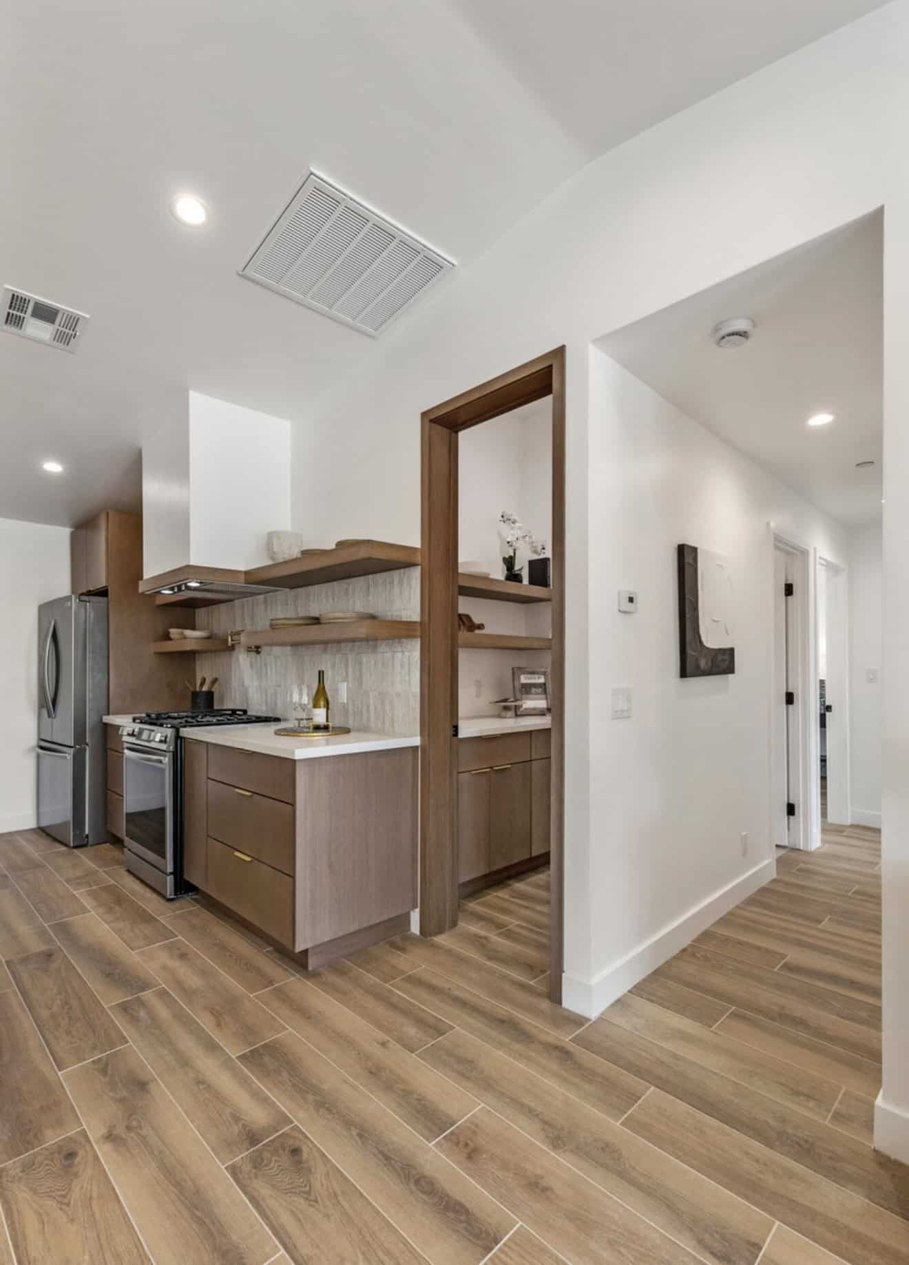 Custom kitchen design with wood cabinetry and open shelving in Phoenix home.