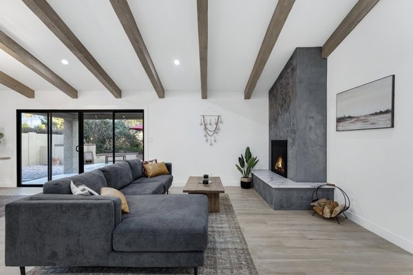 Elegant living room featuring a sleek fireplace, large windows, and contemporary decor for stylish c.