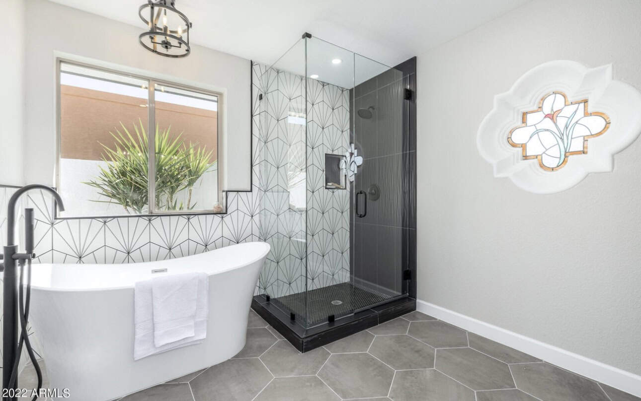 Contemporary bathroom featuring a walk-in shower and freestanding bathtub with stylish decor.