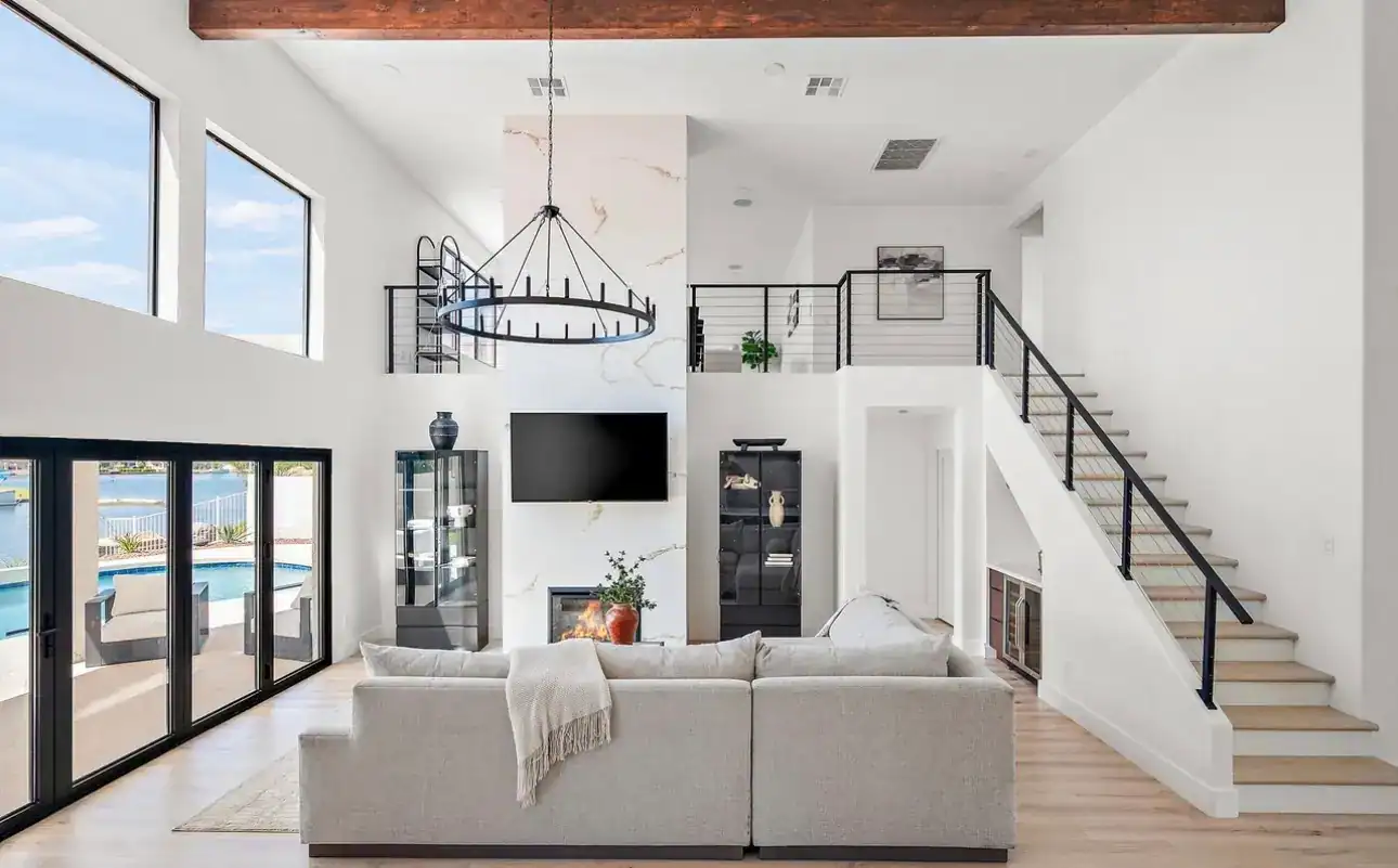 Spacious living room featuring high ceilings, large windows, and contemporary decor by Prolific Buil.